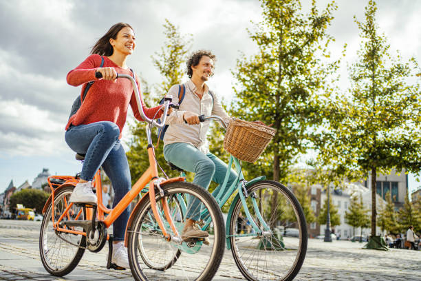 istock Romantic couple riding bicycles through the city 1728007984