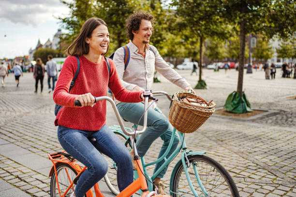 istock Romantic couple riding bicycles through the city 1728007991