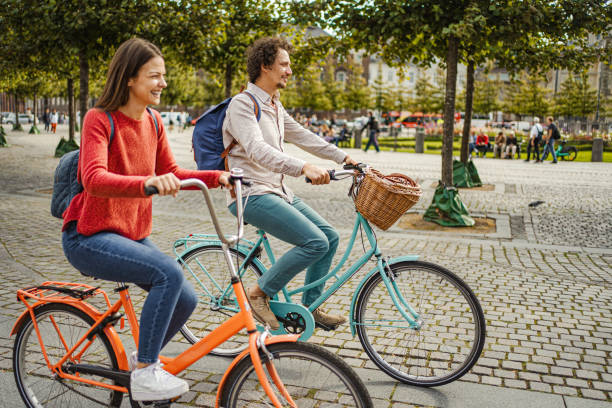 istock Romantic couple riding bicycles through the city 1728007993