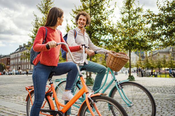 istock Romantic couple riding bicycles through the city 1728007997