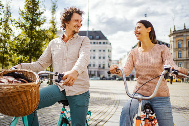 istock Romantic couple riding bicycles through the city 1728008014