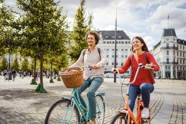 istock Romantic couple riding bicycles through the city 1728008028