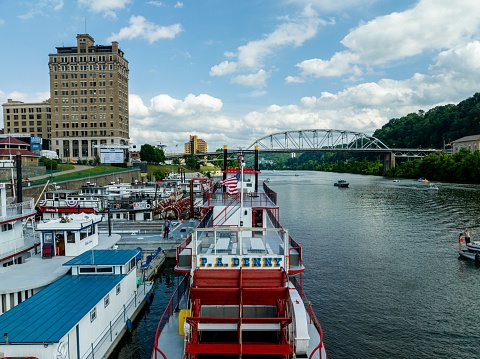 Charleston, United States – July 03, 2023: A scenic view of vintage sternwheel boats sailing on the Kanawha River in Charleston, West Virginia during the annual Regatta event