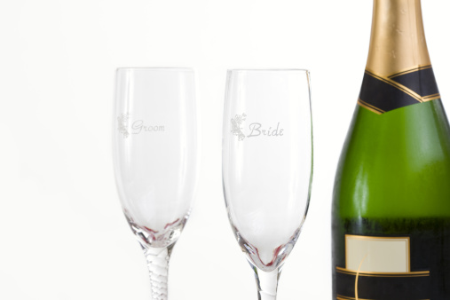 Front of champagne bottle with bride/groom glasses. Copy space to left. CLICK FOR SIMILAR IMAGES AND LIGHTBOX WITH MORE WEDDING IMAGES.