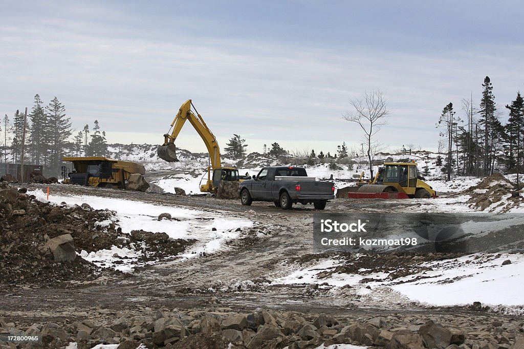 Site Preparation Starting the ground work in late winter on a large project involving land excavation,roadways and finally building construction, expected to be finished by fall. Construction Site Stock Photo