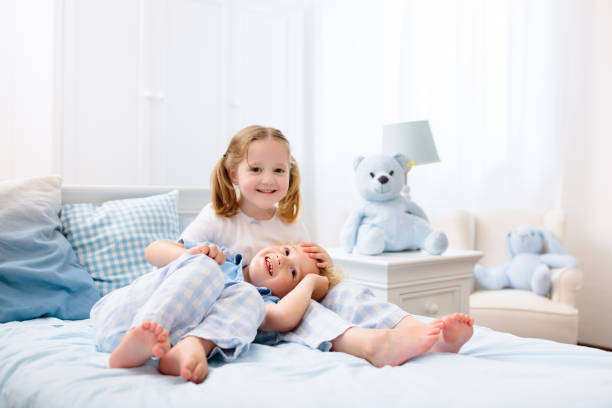 istock Kids playing in white bedroom 1728009921