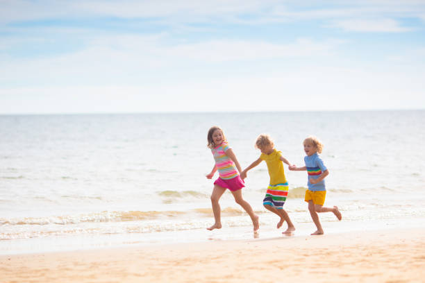 istock Kids play on tropical beach. Sand and water toy. 1728013675