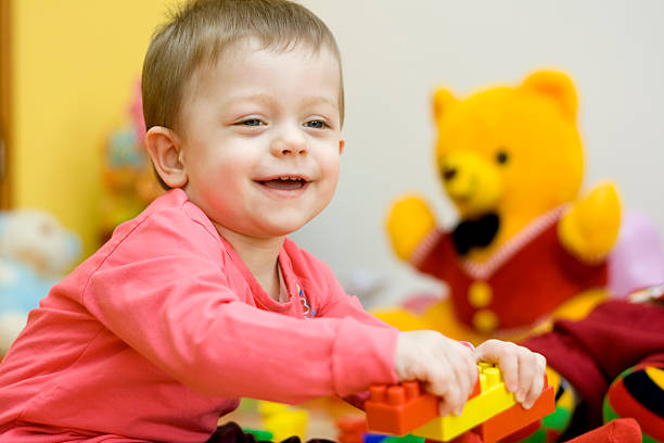 istock Smiling baby playing with toys 172801507