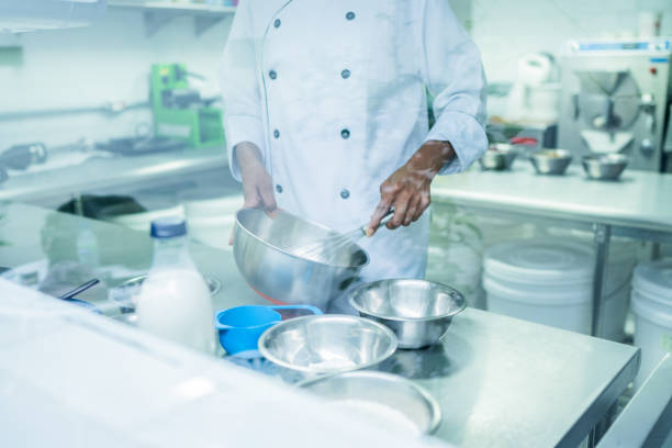 istock Chef mixing ingredients in a mixing bowl at commercial kitchen 1728015415