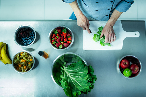 Chef cutting kale at commercial kitchen