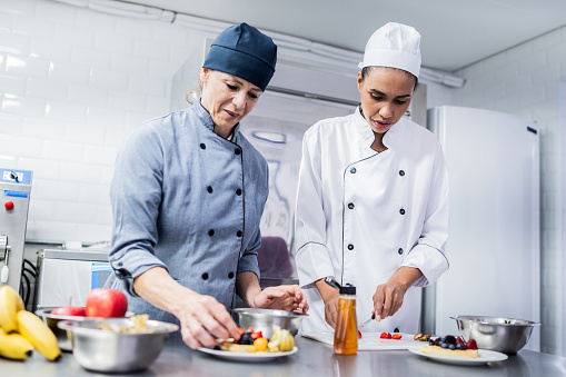 Chefs preparing food at commercial kitchen