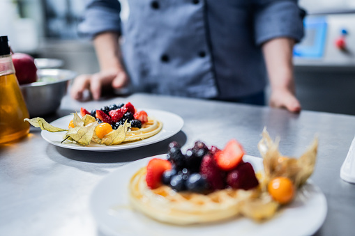 Close-up of a waffle with fruit on the commercial kitchen counter