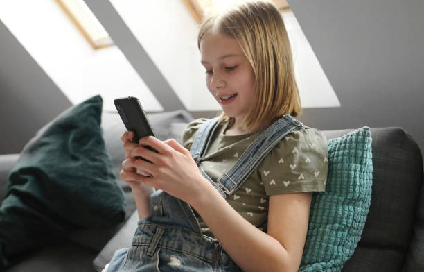 istock Child girl with smartphone at home 1728036258
