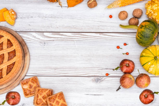 istock Pumpkin Pie, Apples, Nuts, Corns and Pumpkins on Wooden Table 1728036293