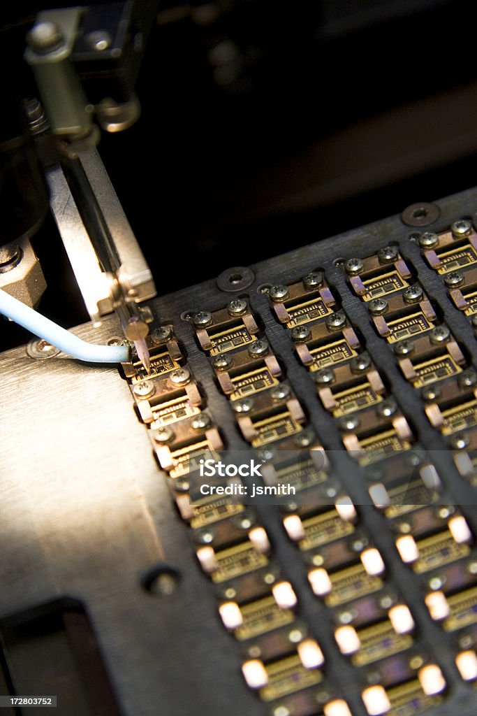 Manufacturing process Close-up of computer chip board being built with automated process Circuit Board Stock Photo