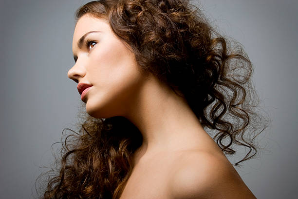 Woman tilting her head and showing her shoulders stock photo