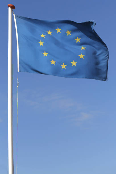 Fluttering flag of the European Union, clear blue sky on the background