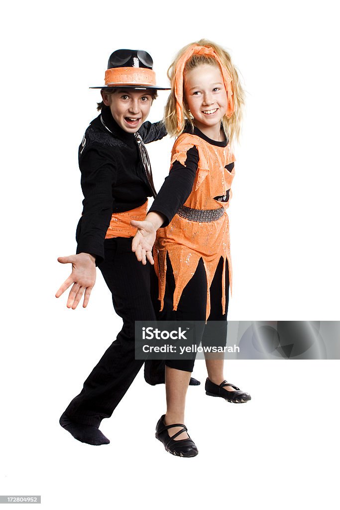 Performers Two children wearing costumes of orange and black isolated on white. Child Stock Photo