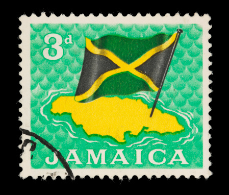 1964 Jamaican stamp depicting a map of Jamaica and the Jamaican flag.  Canon 40D with 100mm macro; no sharpening.