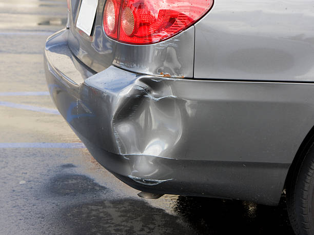 car dent A dented bumper on a nice car. bumper stock pictures, royalty-free photos & images