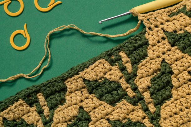 istock Creating a yellow green crocheted fabric with foliage pattern. 1728060142