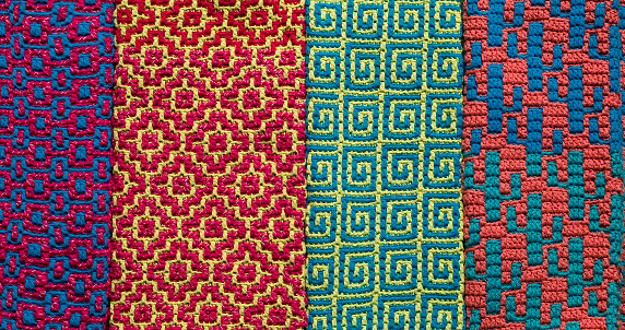 Bright colorful crochet texture with abstract patterns. Knitted background.