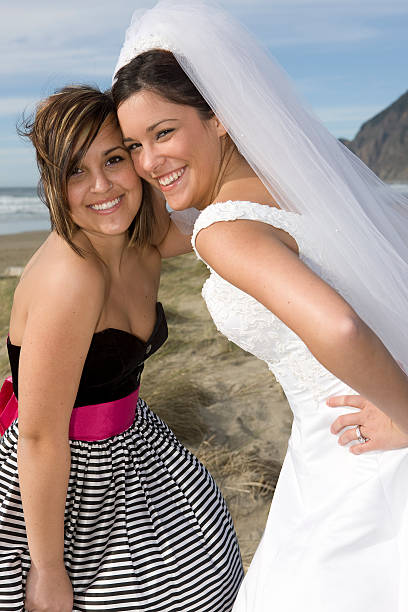 istock Bride with Bridesmaid at Beach, Smiling and Having Fun 172807215