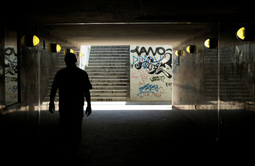 Man walking in underground tunnel