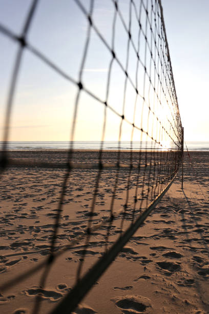 istock beach volleyball sand court at sunset 1728074904