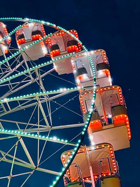 istock Close up of a ferris wheel illuminated at night time 1728075294