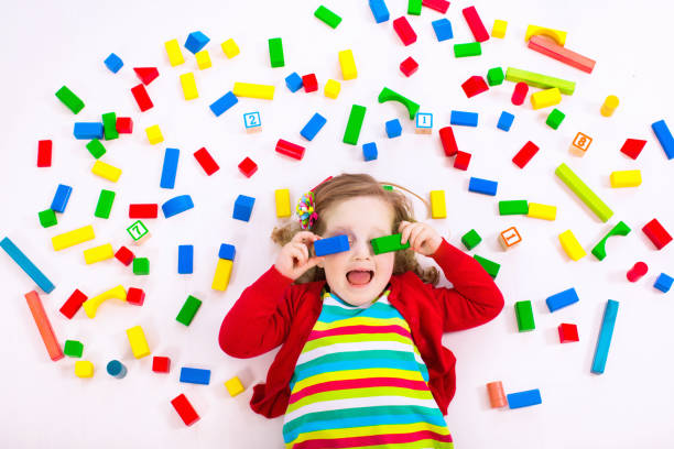 istock Little girl playing with wooden blocks 1728076730