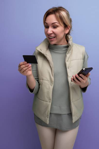 istock young 30s woman bought a smartphone with a plastic card 1728076734