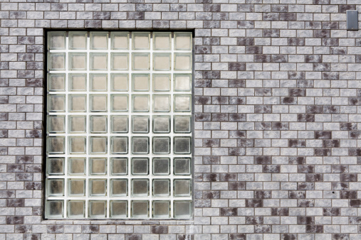 Glass block window in brick wall.
