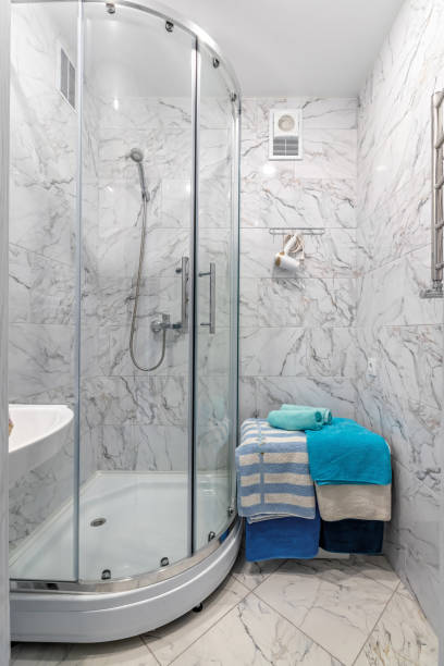 istock A simple bathroom with a silver shower, a square mirror and classic white tiles 1728079497
