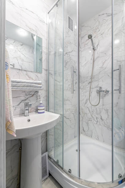 istock A simple bathroom with a silver shower, a square mirror and classic white tiles 1728080018