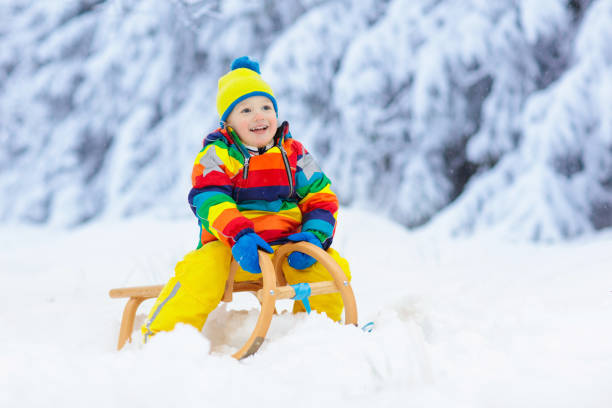 istock Boy on sled ride. Child sledding. Kid on sledge 1728080567