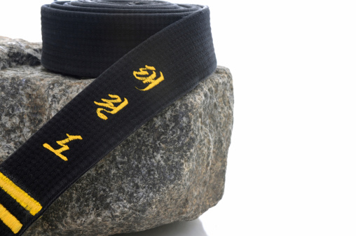 Black belt on a rock (Tae Kwon Do embroidered on the belt).