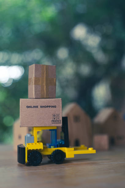 istock Mini forklift truck load cardboard box with text online shopping. Fast delivery. 1728085661