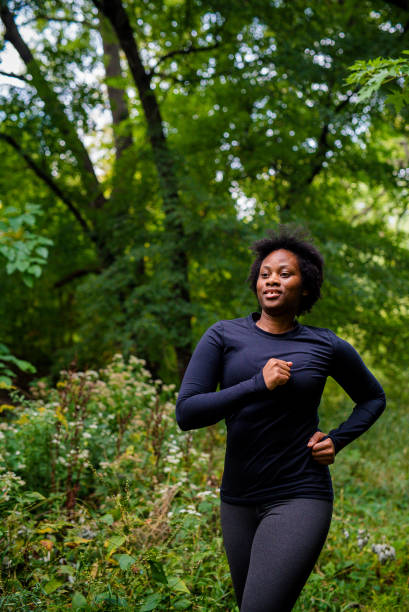 istock Young black woman running 1728094410