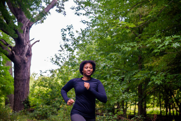 istock Young black woman running 1728095576