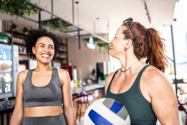 Friends talking and walking after playing volleyball