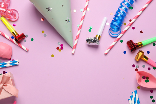 Festive birthday accessories with copy space on a pink background.