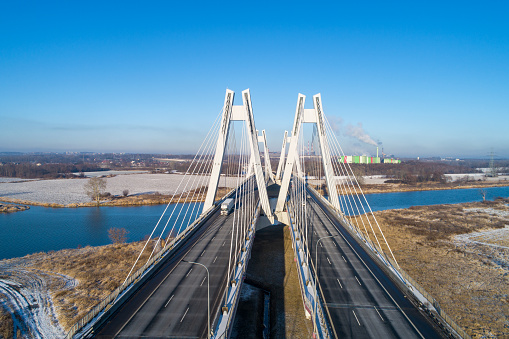 New modern Macharski double cable-stayed three-lane suspension bridge over Vistula River in Krakow, Poland. Aerial view in winter. Part of the ring road around Krakow
