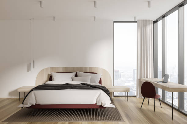 istock Cozy hotel bedroom interior with bed and workplace, panoramic window 1728114576