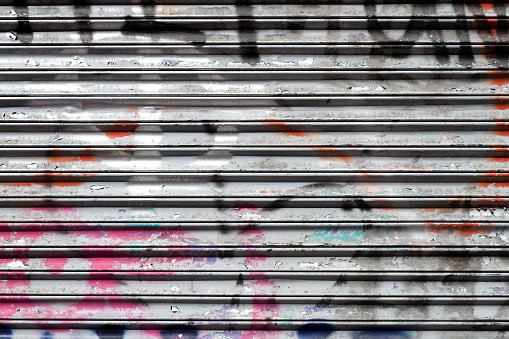 Brussels, Belgium – December 02, 2022: Colorful impression on an empty skateboard park with dense grafitti against an urban background