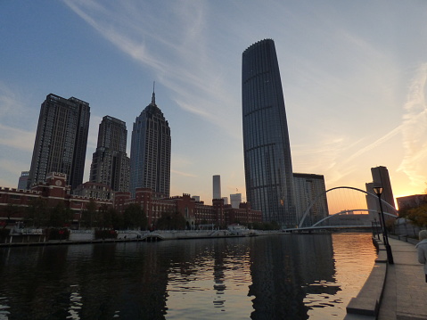 Xi'an, China – February 12, 2023: The architecture of Tianjin on the banks of Haihe River as the sun begins to set.
