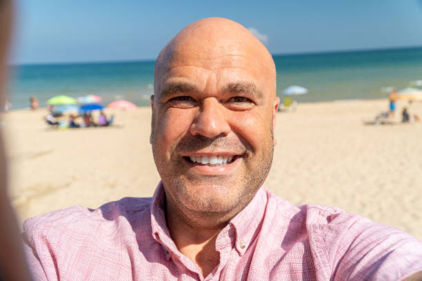 istock Happy man takes a selfie outdoors on the beach 1728141050