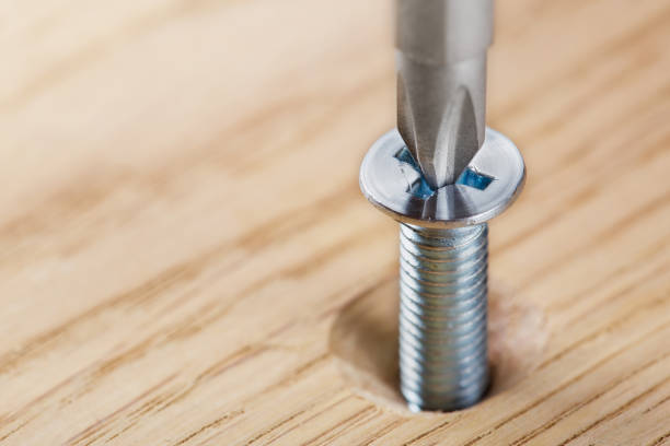 istock screwdriver screw in a wood oaks plank 1728143876