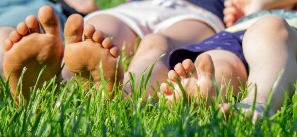 istock Children's legs on green grass. Selective focus. 1728150103
