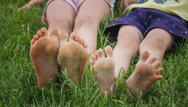 istock Children's legs on green grass. Selective focus. 1728150346